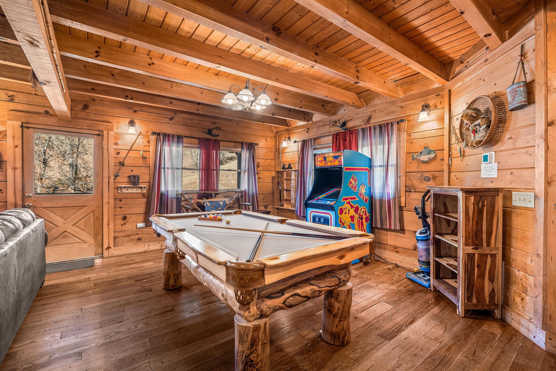 Pool table and arcade game at A Beary Nice Cabin, a 2 bedroom cabin rental located in Pigeon Forge