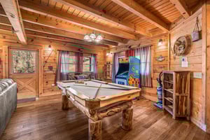 Pool table and arcade game at A Beary Nice Cabin, a 2 bedroom cabin rental located in Pigeon Forge