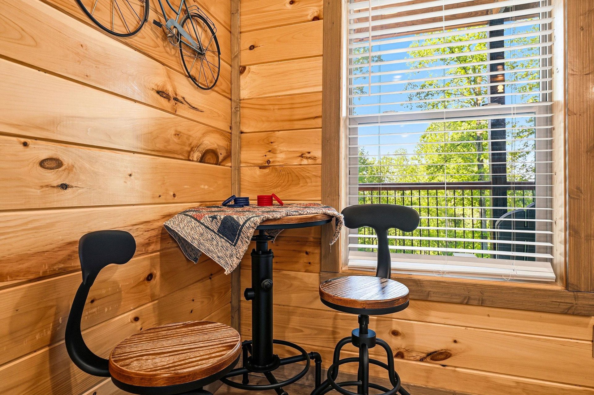 Your cozy cabin corner features rustic charm with a perfect workspace and bike storage, all while enjoying peaceful tree views.