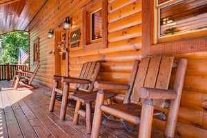 Step outside onto your private covered porch and settle into handcrafted log chairs. Feel the warmth of the natural wood as you breathe in the fresh mountain air and watch the leaves rustle just beyon