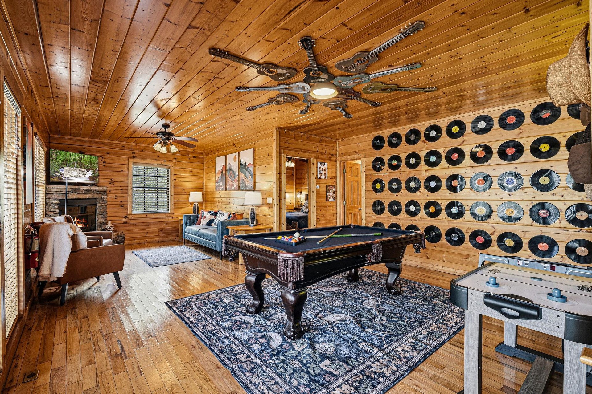 Your private game room awaits with a pool table, vinyl collection, and cozy fireplace for unforgettable evenings of fun and relaxation.