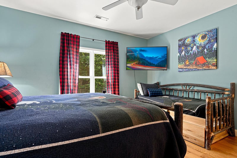 Your cozy retreat with rustic log beds, calming blue walls, and mountaininspired artwork. Relax under the ceiling fan, watch your favorite shows, and let red plaid accents welcome you home.