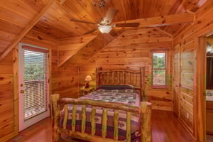 Queen bedroom on the upper floor with en suite bath at Four Seasons Lodge, a 3bedroom cabin rental located in Pigeon Forge