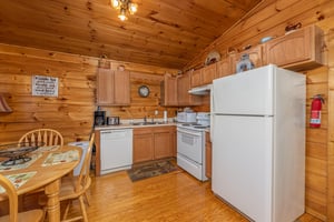 Kitchen with white appliances at A Moment in Time, a 2 bedroom cabin rental located in Pigeon Forge