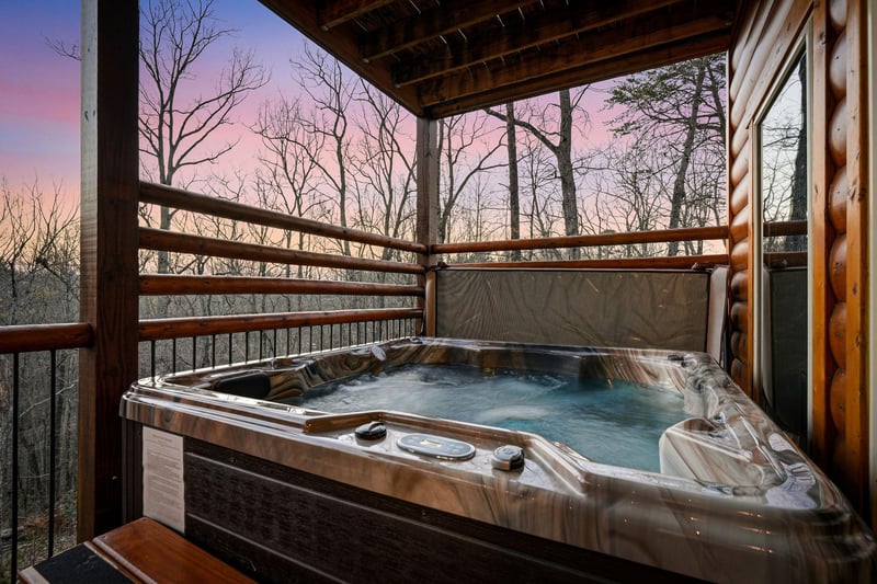 Soak in your private hot tub while sunset paints the sky in dreamy pastels through the trees.