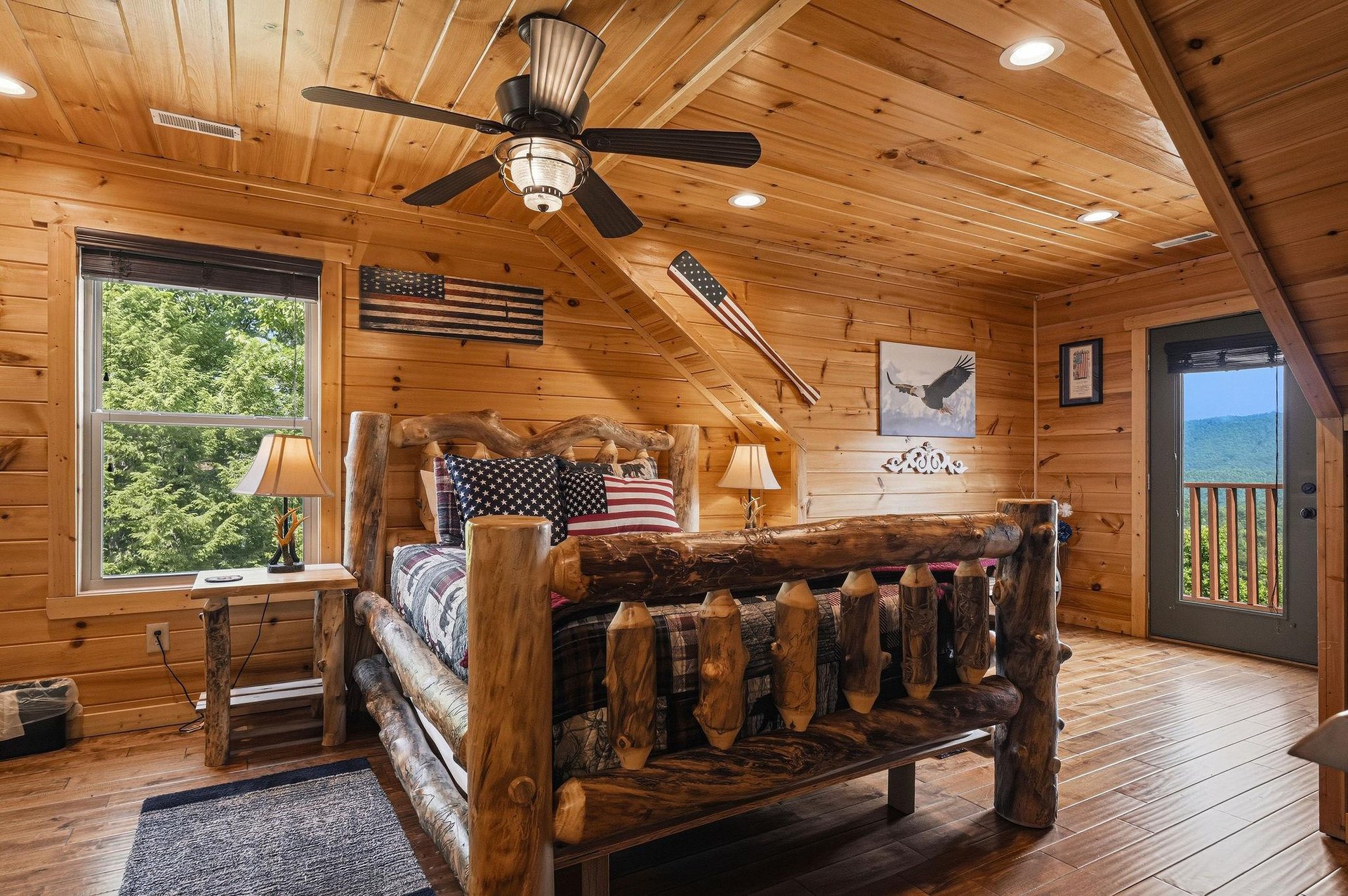 Your cozy mountain retreat awaits—curl up in this handcrafted log bed, soak in forest views, and step onto your private deck to breathe in the fresh mountain air.