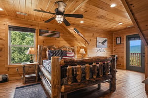 Your cozy mountain retreat awaits—curl up in this handcrafted log bed, soak in forest views, and step onto your private deck to breathe in the fresh mountain air.