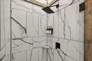 Step into your luxurious marbleclad shower sanctuary, where rainfall flows and premium amenities await your perfect morning routine.