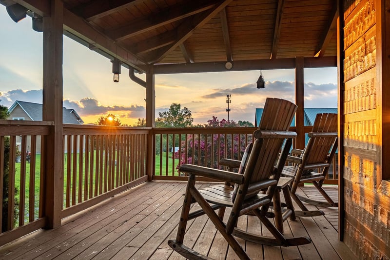 Sink into your private rocking chair as the sun dips below the horizon, painting the sky in warm hues just beyond your covered porch. This peaceful retreat is the perfect spot to unwind after a day of