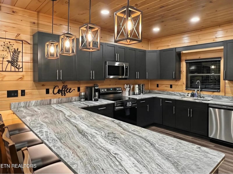 Your fullyequipped kitchen features stunning granite countertops and modern appliances, perfect for creating memorable meals during your mountain getaway.