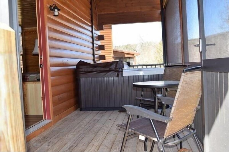 Your private balcony invites relaxation with comfortable seating and a soothing hot tub, perfect for unwinding while enjoying mountain views.