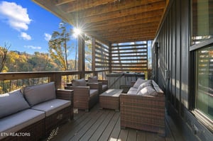 Soak in breathtaking autumn views from your private covered balcony, where sunlit mountain vistas and comfortable lounge seating create the perfect spot to unwind after a day of exploring.