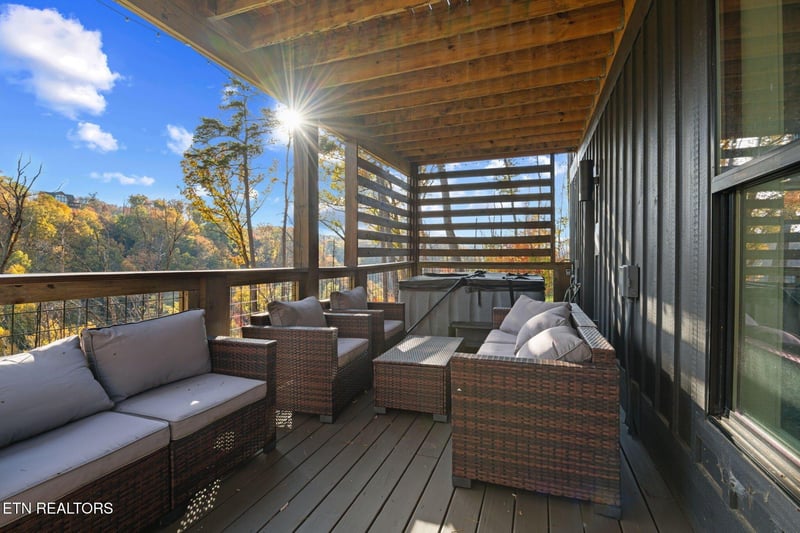 Soak in breathtaking autumn views from your private covered balcony, where sunlit mountain vistas and comfortable lounge seating create the perfect spot to unwind after a day of exploring.