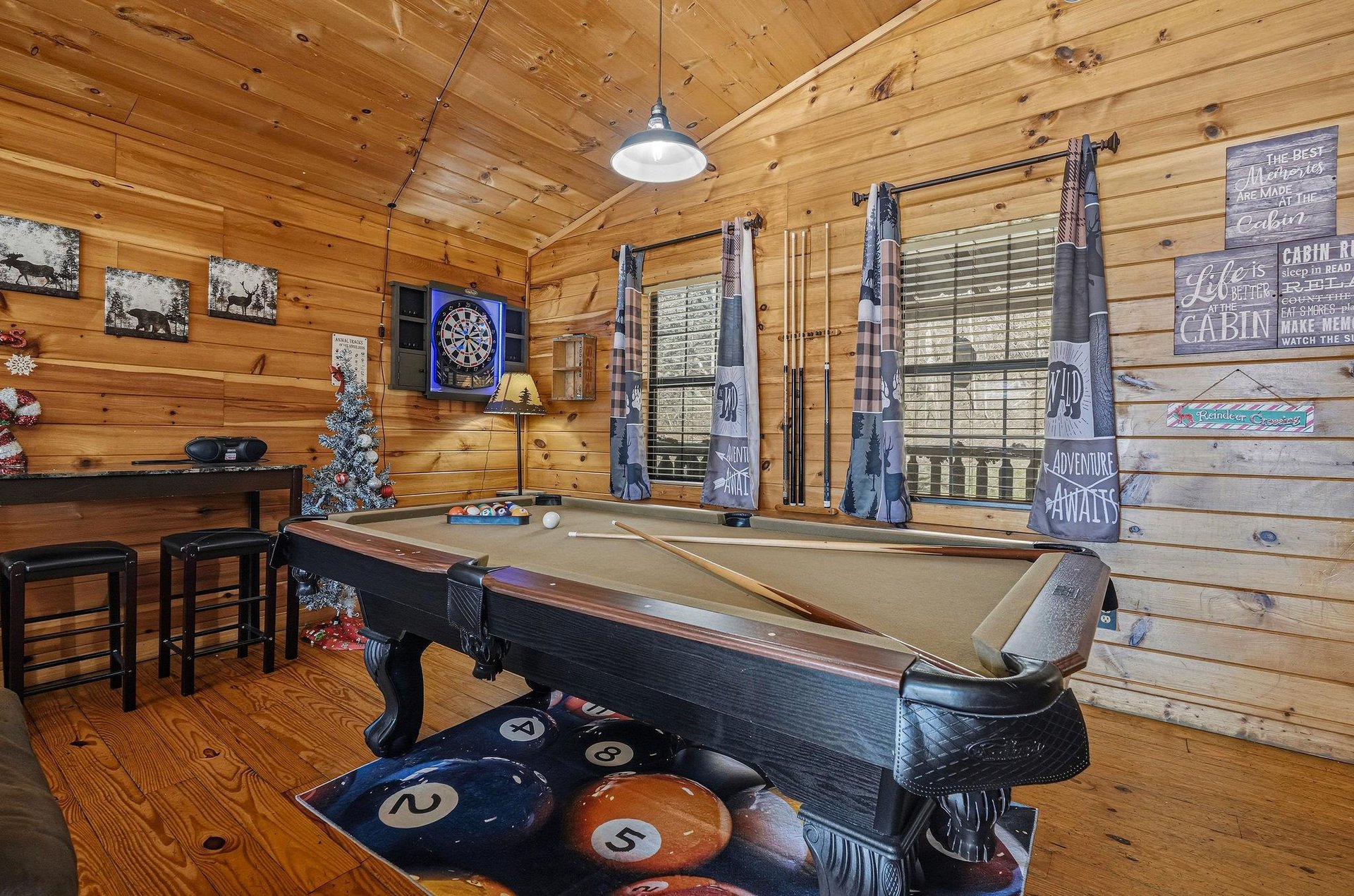 Challenge friends to pool or darts in your rustic game room, where woodlined walls and cozy seating create the perfect retreat.