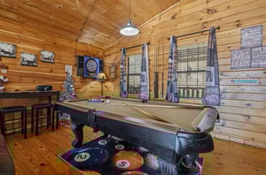 Challenge friends to pool or darts in your rustic game room, where woodlined walls and cozy seating create the perfect retreat.