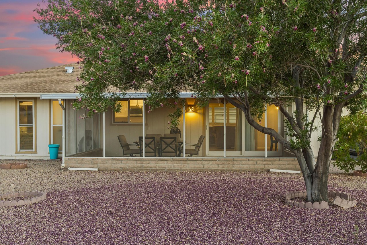 Screened patio with fan, and outdoor dining table and chairs for 6 guests. Large outdoor space in backyard with BBQ, additional table, and fencedin yard.