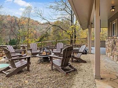 Gather around your private fire pit on this spacious terrace, where mountain views and cozy seating create perfect evenings under the stars.