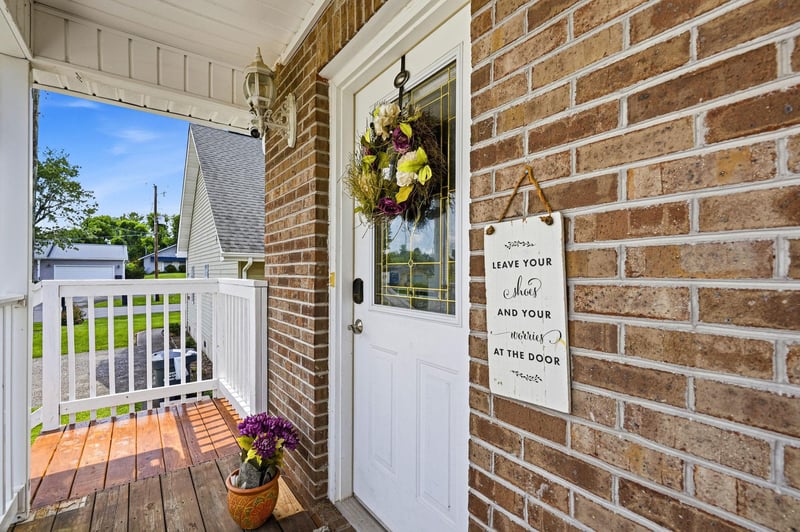 A charming brick facade and covered porch mark the entrance to your home away from home. Step through the welcoming front door into your private retreat.