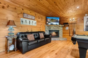 Sofa bed beside stone fireplace