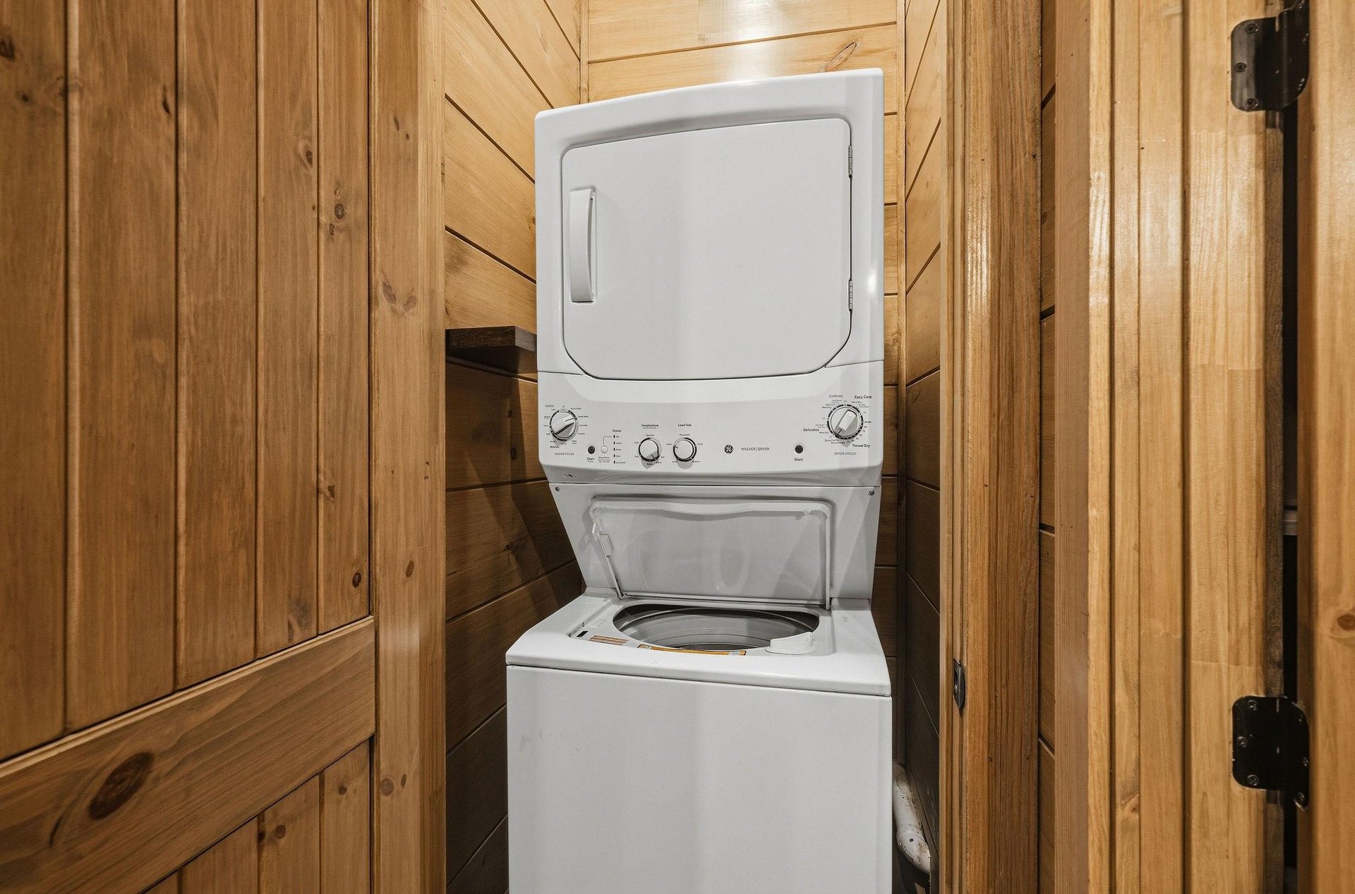 Your private laundry area keeps your clothes fresh throughout your stay in this cozy woodlined space.