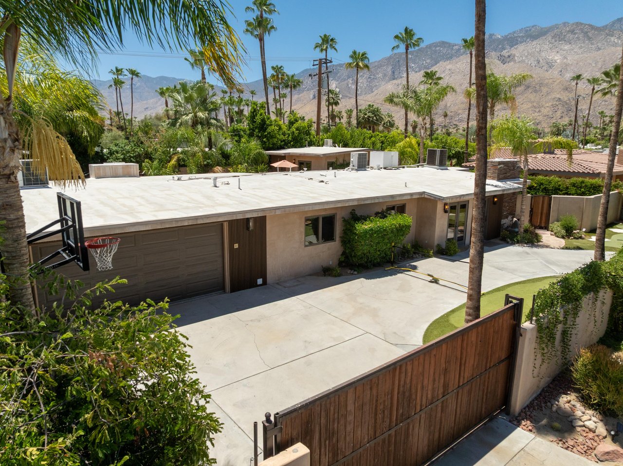 Basketball hoop, putting green, and pickleball located at the front of the home.