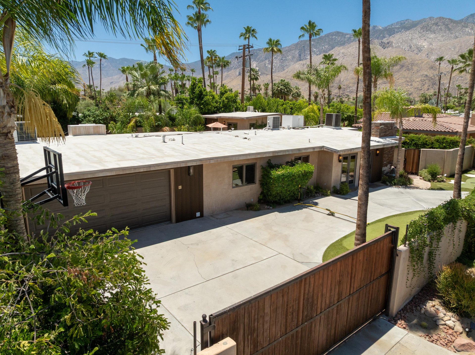 Basketball hoop, putting green, and pickleball located at the front of the home.
