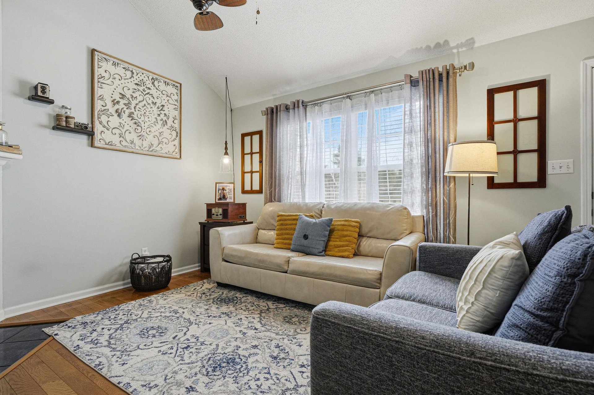 Sink into plush sofas and let natural light fill your cozy living space, where thoughtful decor and warm touches invite you to truly relax and feel at home.