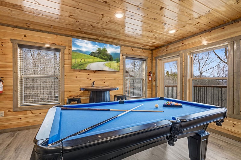 Challenge friends to a game in your private billiards room, surrounded by warm wood and scenic mountain views.