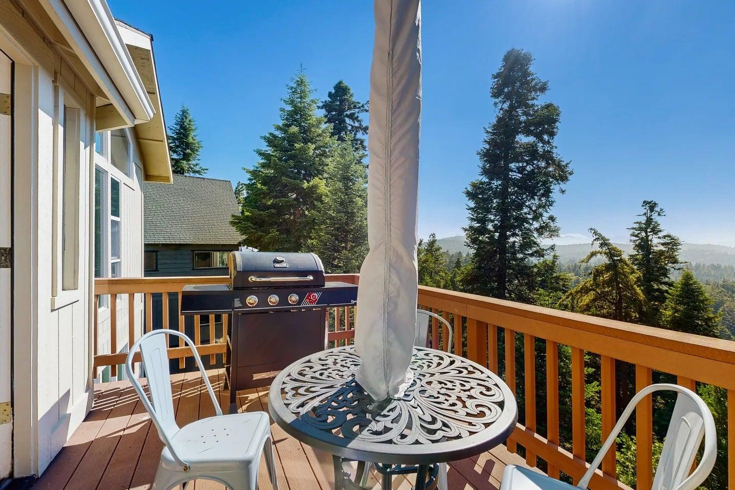 Beautiful, expansive deck with mountain  treetop views, outdoor dining, and BBQ.