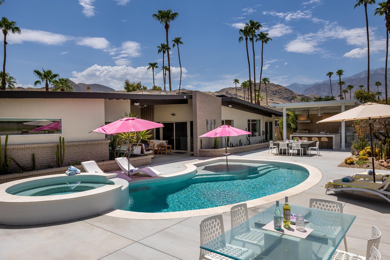 Private pool and spa overlooking the golf course. Additional features include outdoor kitchen, outdoor dining space, and a firepit.