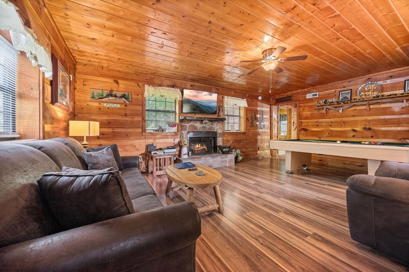 Living room with fireplace and TV at Beary Good Time, a 1bedroom cabin rental located in Pigeon Forge