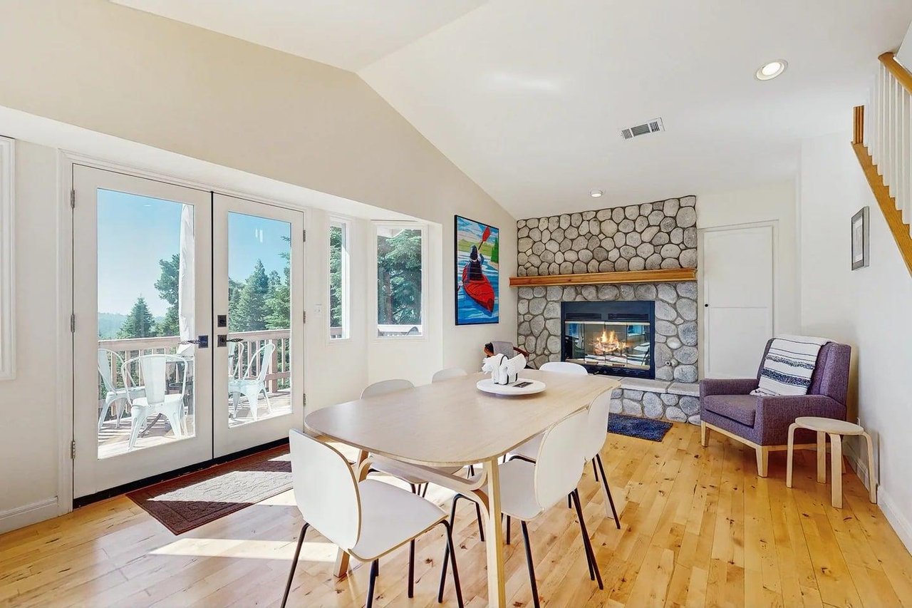 Dining area with table, chairs for 6 guests, and 1 of 3 fireplaces.