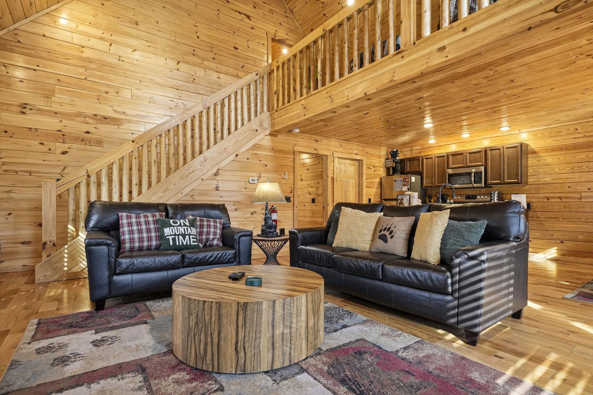 Relax in this warm rustic living space with plush leather sofas and handcrafted wood touches.
