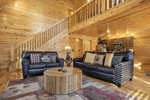 Relax in this warm rustic living space with plush leather sofas and handcrafted wood touches.