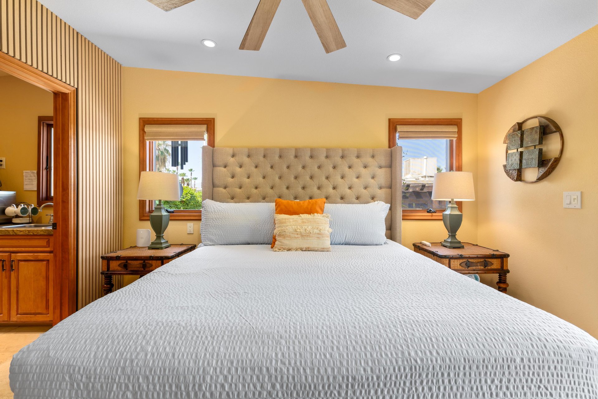 Queen size bed, kitchenette, ensuite bathroom, and patio access.
