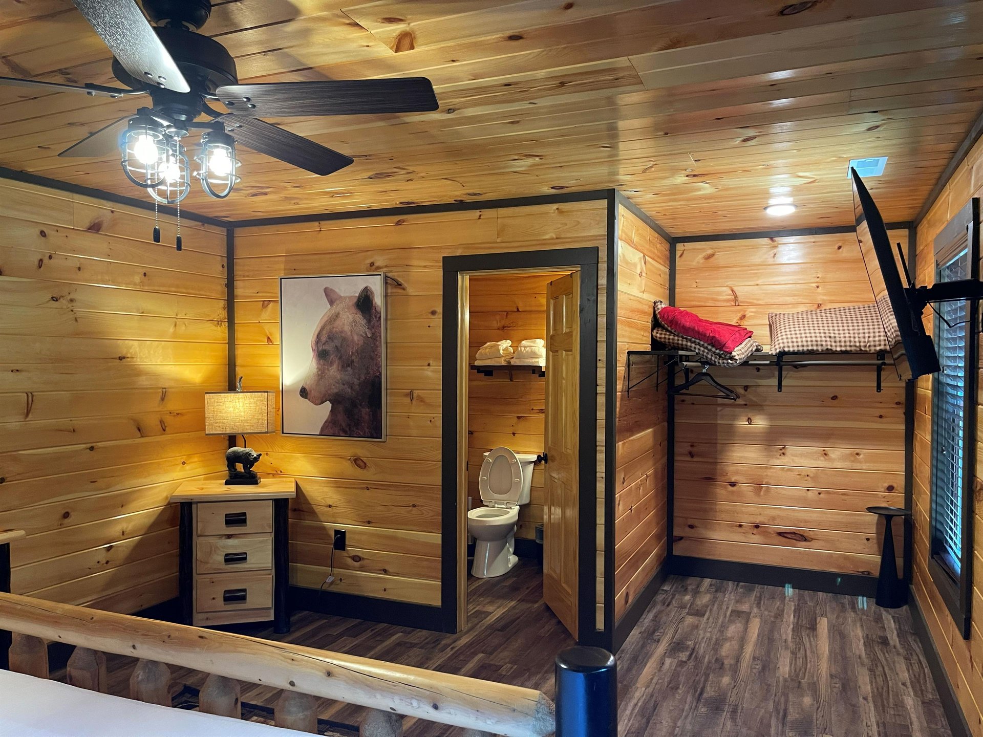 Cozy cabin warmth meets clever design in your rustic retreat. Woodpaneled walls, ambient lighting, and a private bath create your home away from home.