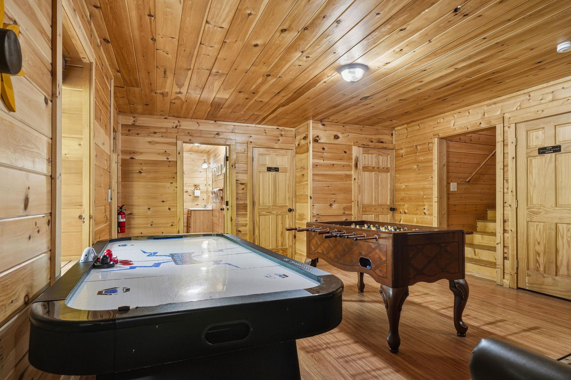 Your own private game room awaits with air hockey and foosball tables surrounded by warm wood walls.