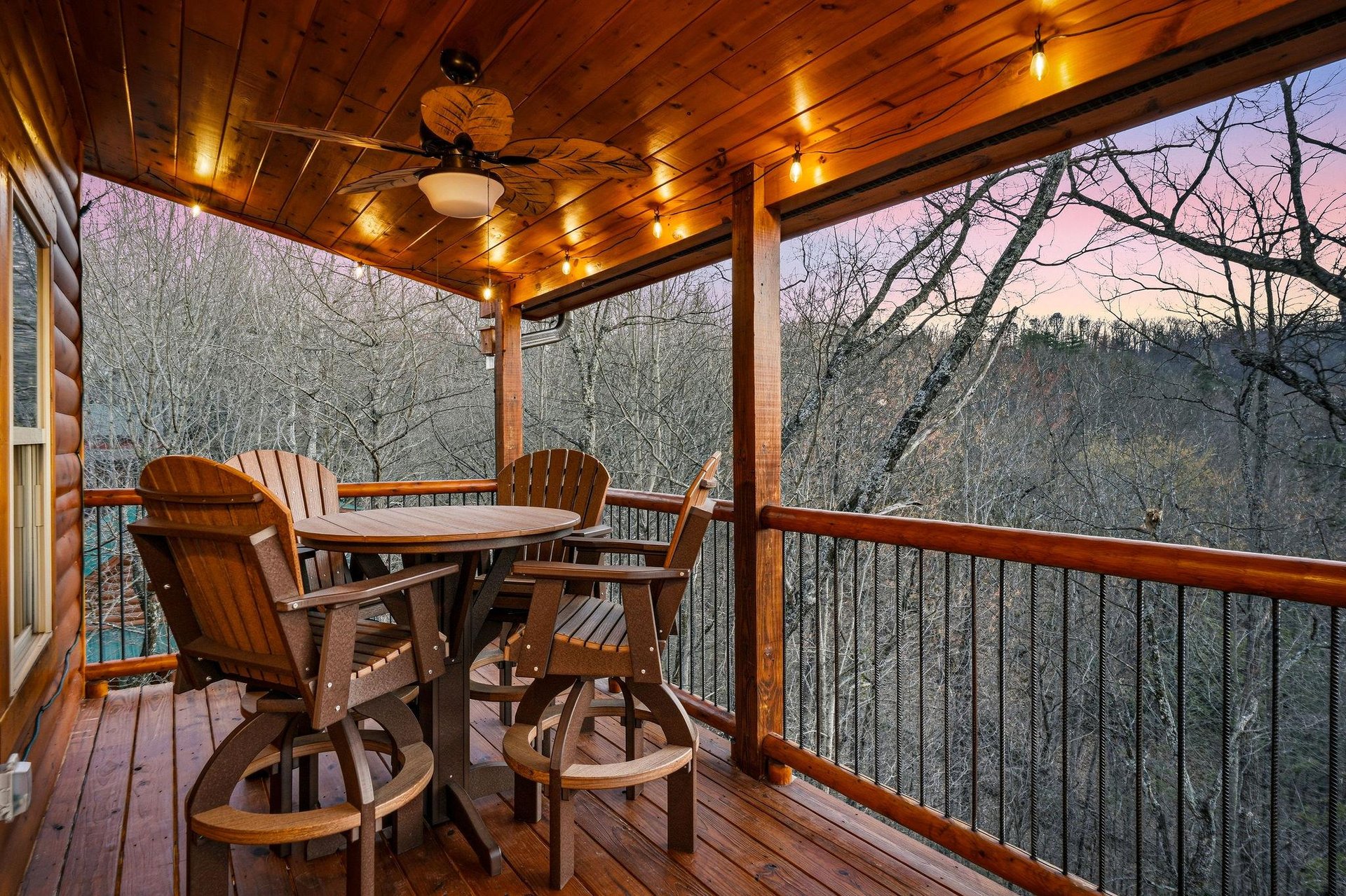 Enjoy your morning coffee on this covered deck with mountain views and twinkling lights creating the perfect ambiance.