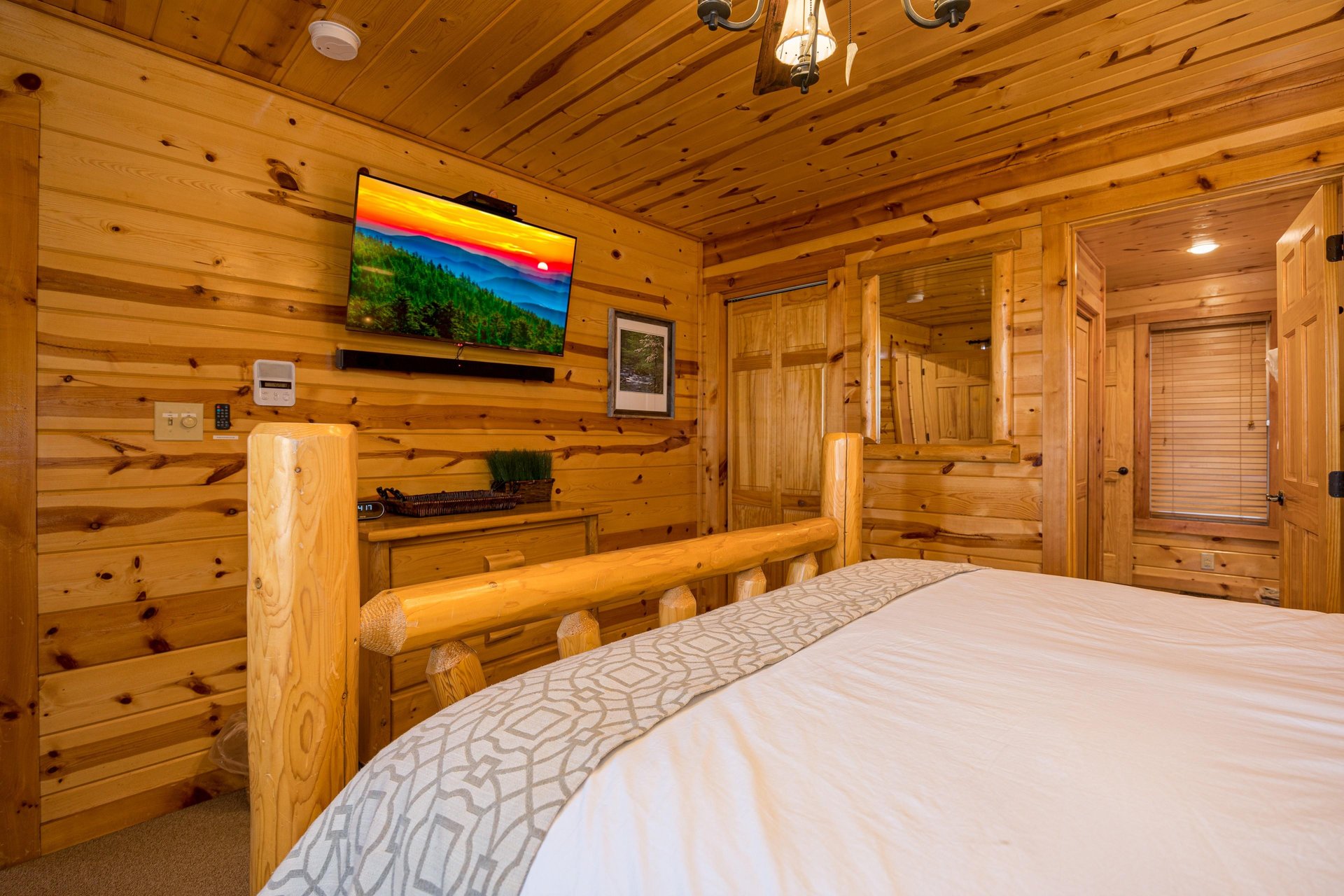 Queen bed facing tv and dresser