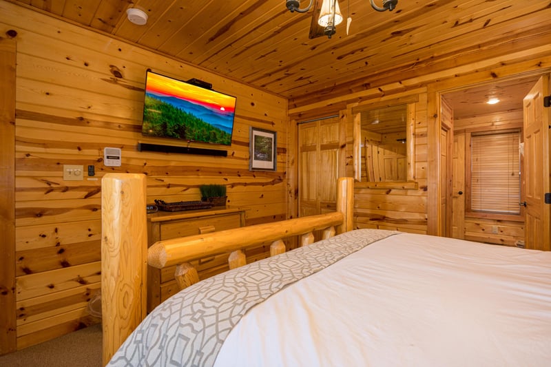 Queen bed facing tv and dresser
