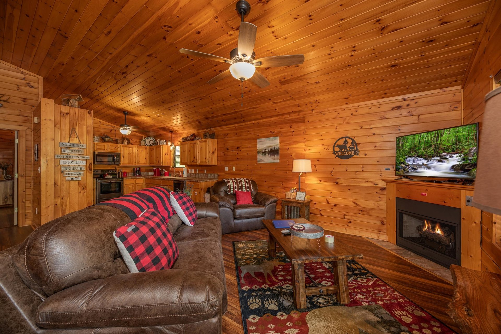 Living room with fireplace and TV next to the open kitchen
