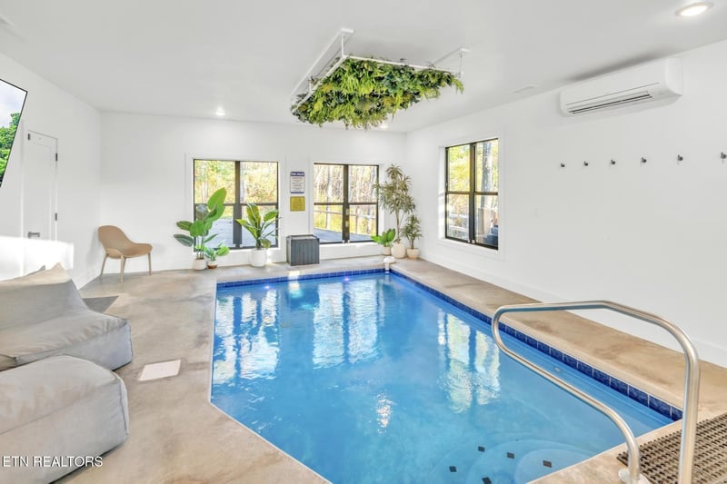 Your own private indoor pool awaits, complete with sunlight streaming through large windows, lush greenery overhead, and a cozy lounging area to unwind in total tranquility.
