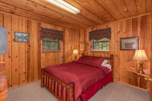 A queensized log bed in the second bedroom at Apple View, a 2 bedroom cabin rental located in Pigeon Forge