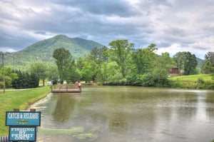 Scenic lake surrounded by mountains offers peaceful fishing opportunities in a natural setting.