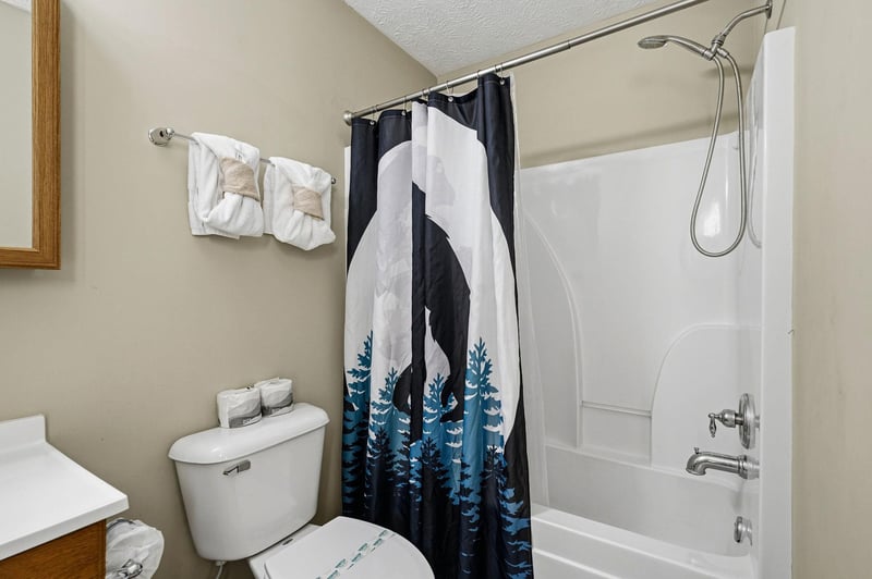 Your private bathroom features a full tubshower combo with fresh towels and natureinspired décor for a relaxing mountain retreat experience.