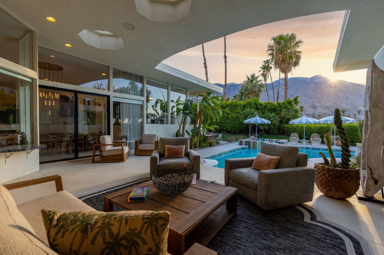 Patio area has plenty of outdoor seating, a fireplace, and gorgeous mountain, golf course, and pool views.