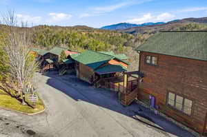 Mountain retreat with rustic cabins nestled among forested hills, offering peaceful escape with scenic valley views and abundant natural beauty.