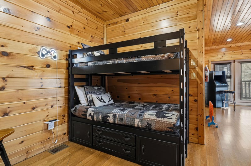 Your cozy rustic bunk room features comfortable beds and builtin storage in warm wood surroundings.
