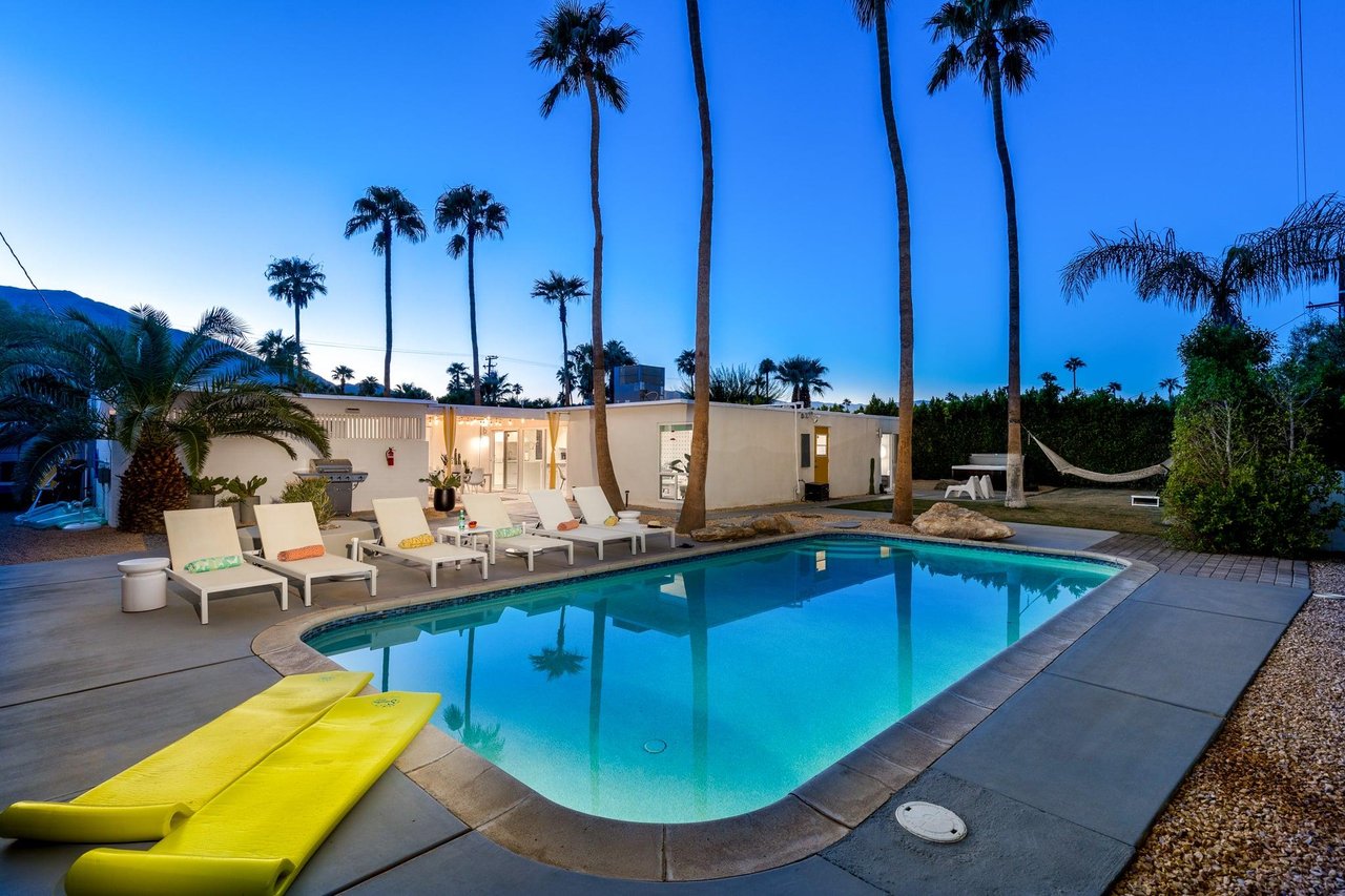 Pebble finish heated pool with an entertainers yard
