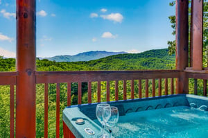 Soak in the hot tub while drinking in sweeping views of lush forests and mountain peaks—a peaceful retreat where relaxation meets stunning natural beauty.